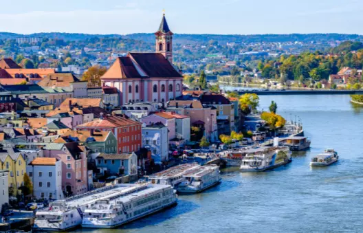 Deluxe small-ship cruise cabin interior with large windows overlooking European waterways